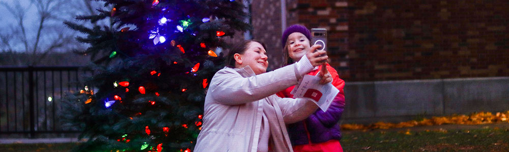 mom and child near Christmas tree
